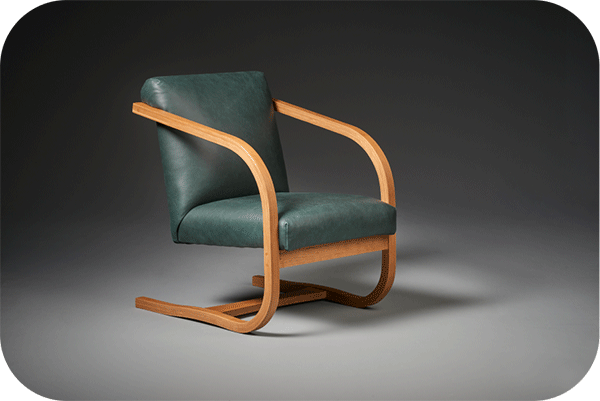 modern chair with bent cherry frame and green leather